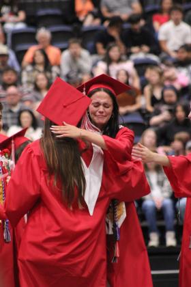 After giving her valedictory speech, Jordyn Dennis gets a hug from a fellow grad during McLoud High School's Graduation Ceremony on May 23 at FireLake Arena.