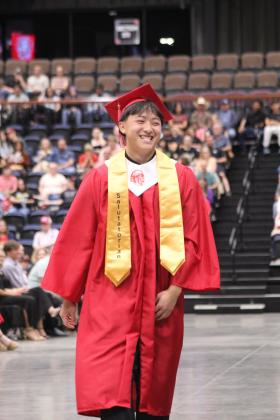 McLoud High School Salutatorian Jonathan Yang walks to the stage to give his address during graduation on May 23 at FireLake Arena.