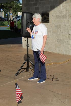 Cathy Cowan speaks about coming from South Africa to become a United States citizen during the presentation, held after the Shawnee Independence Day Parade at Woodland Veterans Park on July 4.