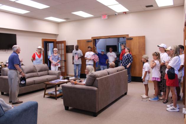 Shawnee Veterans Memorial Committee President Bill Ford, far left, speaks to a crowd about the Pottawatomie County Veterans Educational Museum after the Shawnee Independence Day Parade and presentation on July 4.