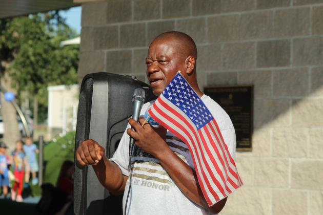 Rev. David Henry tells about his journey from Antigua and Barbuda to become a United States citizen during the presentation, held after the Shawnee Independence Day Parade at Woodland Veterans Park on July 4.