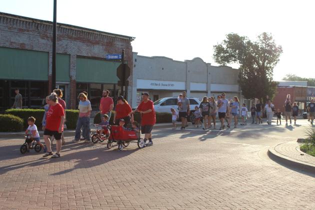 Children and families walk on Main Street in the Shawnee Independence Day Parade on July 4 in celebration of the 250th USA anniversary. The parade was led by the Oklahoma Jazz Preserve and began at 7:30 am at the Pottawatomie County Museum. It ended at Woodland Veterans Park.