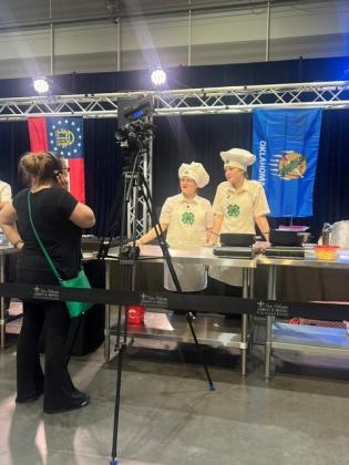Madison Maddox of Dale, left, and Tori Nelms of North Rock Creek compete on the "Great American Seafood Cookoff: 4-H Edition" TV show on July 26 in New Orleans, LA, and took fourth place with their Pecan-Crusted Catfish with Sweet Potato Purée and Peach Andouille Sausage Maque Choux, using Oklahoma-sourced ingredients. Photo provided