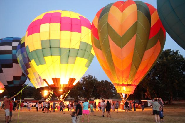 Around 15 hot-air balloons from Oklahoma and surrounding states participated in the balloon glow on Friday night, Aug. 7, during the FireLake Fireflight Balloon Festival. This year, they allowed the public to walk among the balloons during the glow.