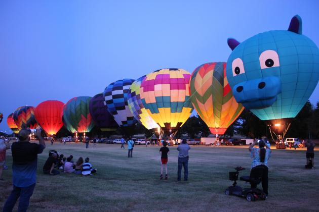 Around 15 hot-air balloons from Oklahoma and surrounding states participated in the balloon glow on Friday night, Aug. 7, during the FireLake Fireflight Balloon Festival. This year, they allowed the public to walk among the balloons during the glow.