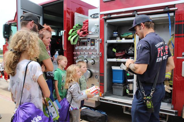 Shawnee firefighter Ko Withrow speaks to a family about the tools of the trade.