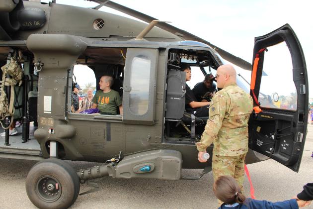 Chief Warrant Officer #3 Ryan Johnson, with the OK Army National Guard out of Tulsa, gives tours of a UH-60M Black Hawk helicopter.