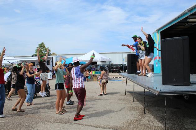 The Shawnee High School students have fun with karaoke and dancing to "Party in the USA" by Miley Cyrus, along with Jamelle Payne and Dion Cooley, at the Party Peeps stage.