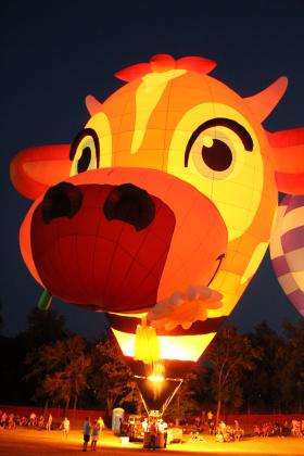 MilkyWay, owned by Bill and Tiffany Kinser, of Guthrie, was among those glowing at the FireLake Fireflight Balloon Festival on Aug. 8. The Kinsers have three generations of family members who are balloon pilots. Photo by Brody Dunagan