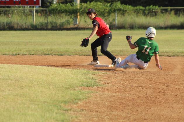 Macomb freshman Kameron Beaver waits for the catch at second, as a Stonewall runner slides toward base, during the Aug. 28 home game.