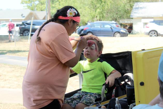 Julisa Valdez, with LOL Cartoons Party Entertainment, gives Jaxon Baker, 4, of Tecumseh, a Spiderman face during the Pottawatomie Go (POGO) Pedal Palooza, held at Rotary Briscoe Boy Scout Park on Sept. 19. There were about 10 vendor and organization booths, a community bike ride and a bicycle obstacle course at the event.