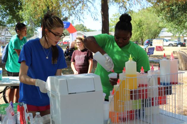 Anna Parrilla and Aaniyah Lambert, with Epic SnoCones, prepare several snow cones for volunteers at the Pottawatomie Go (POGO) Pedal Palooza, held at Rotary Briscoe Boy Scout Park on Sept. 19. In addition to POGO volunteers, members of Galilee Baptist Church were helping out. There were about 10 vendor and organization booths, a community bike ride and a bicycle obstacle course at the event.
