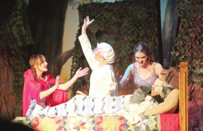 Granny (Arianna Vermillion) emerges from the Wolf (Makalah Jessup) after Little Red Ridinghood (Makenzi Stiles), left, and she were swallowed during “Into the Woods Jr.” on April 8 at the Tecumseh High School Alumni Center. Also shown is the Narrator (Zoey Edwards). The play was presented by the Vocal Music Program, and Jessup, a student teacher, filled in for Amiah Vermillion who also played Lucinda, with three hours to prepare.