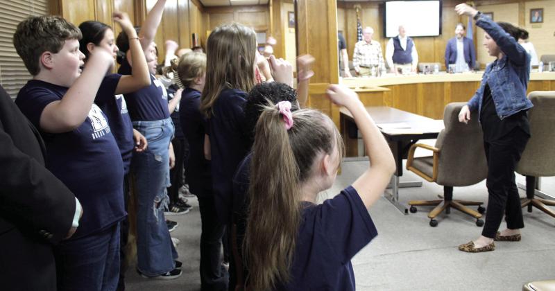 The Will Rogers Elementary Honor Choir (half of the full choir) is led by Music Teacher Tara Wilson in an audience sing-along of “Oklahoma!” during the Shawnee Board of Education meeting on Feb. 6. They also sang “What the World Needs Now” and “1, 2, 3, 4” in honor of Valentine’s Day. Countywide &amp;amp; Sun/Natasha Dunagan