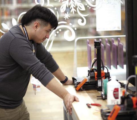 A staff member sets up a new 3D printer in the Shawnee Public Library’s Maker Lab. Photo provided.