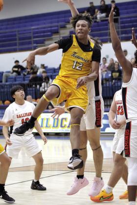 Tecumseh’s Sherman Mitchell makes a jump pass to Jekhi Owens in the fourth quarter of the Bethel First United Tournament Consolation Championship with Sallisaw on Dec. 14. The Savages lost to Pauls Valley, 60-62; beat Bethel, 71-52; and fell to Sallisaw, 60-79. Countywide &amp; Sun/Natasha Dunagan