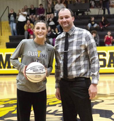 Tecumseh senior Kenzli Warden received a personalized basketball during the game on Feb. 7 after reaching 1,500 high school career points. Warden is shown here with Head Coach Eldon Gentry. Photo provided by Kenetta Lisenbee.