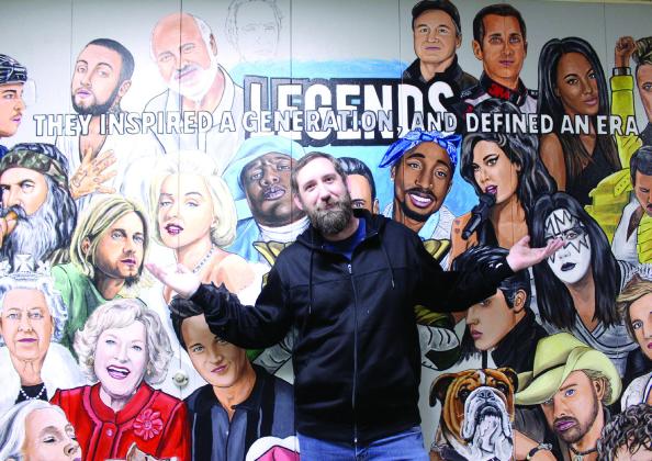 Tecumseh Middle School Art Teacher Kelly Renken poses in front of the second section of the Wall of Legends. Natasha Dunagan, Countywide &amp; Sun