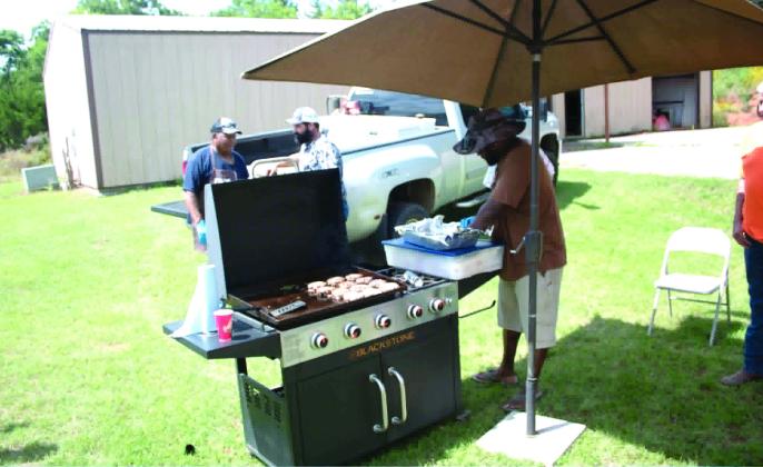 James Sumlin, Jr., works on getting the hamburgers ready for a fundraiser at the Brooksville Community Center on June 20. Carter's Beef donated 100 pounds of hamburger for the event, which raised money for the Brooksville Cemetery pavilion and restrooms. Photo courtesy of Ashaley Crawford
