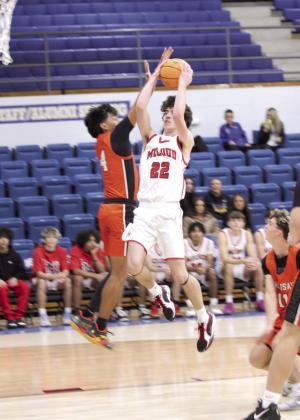 McLoud's Edan Litherland aims and scores in the Bethel First United Basketball Classic game against Sallisaw on Dec. 11. The Redskins won that game, 60-51; lost to Perkins-Tryon, 4857; and beat Tecumseh, 56-55, to take third in the three-day tournament. According to a McLoud Athletics Facebook post, Litherland was named to the All-Tournament Team. Natasha Dunagan, Countywide &amp;amp; Sun