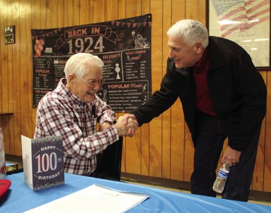 Shawnee Mayor Ed Bolt, right, wishes Noah “Sonny” Hines a happy 100th birthday at the Veterans of Foreign Wars Post 1317, Feb. 5. Hines said he has also had parties at his church and with his fellow “railroaders,” and his family and friends will be celebrating at a Shawnee restaurant later that month. File photo