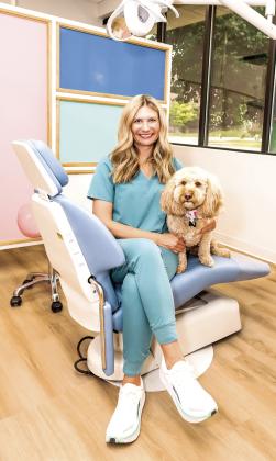 Dr. Sarah Karnish poses with her therapy dog Teddy at Shawnee Pediatric Dentistry. Karnish was nominated as one of Pottawatomie County's Inspiring Women. Photo provided