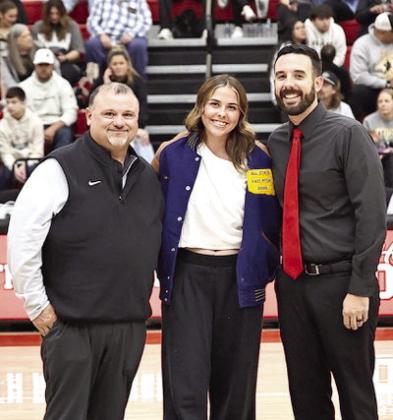 North Rock Creek's Sophie Morris receives her fast pitch all state jacket from coaches Josh Ray and Mike Cox. Photo Provided by Gowin Photography