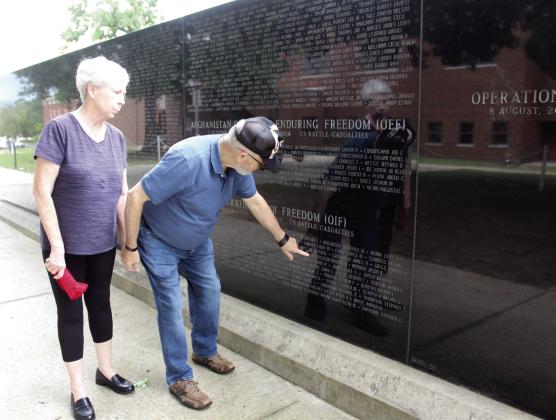 Linda and David Hendrickson point out where their son's name is on the Oklahoma Veterans Memorial Wall at Woodland Veterans Park in Shawnee during the Fifth Annual Gold Star Families Memorial Ride on May 24. Their son, Robert T. Hendrickson, was the last one killed in his unit during Operation Iraqi Freedom on Feb. 1, 20 years ago. Natasha Dunagan, Countywide &amp; Sun