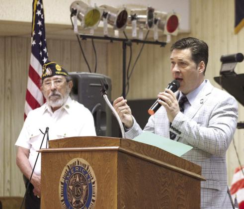 Oklahoma Senator Shane Jett speaks on Memorial Day, May 26, at American Legion Post 260 in Tecumseh, as Post Adjutant William Gammage listens. Jett reminded attendees that those who stormed the beaches of Normandy on D-Day were "little more than boys," but they "were fighting for mom, dad and a future that they believed in." Natasha Dunagan, Countywide &amp; Sun