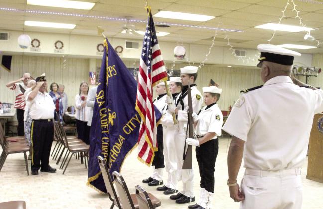 Memorial Day Ceremony attendees salute the flag as the national anthem is played at American Legion Post 260 in Tecumseh on May 26. Those serving in the U.S. Naval Sea Cadets Patriot Division Color Guard are Gabriel Synkowski, Diana Murray, Aaron Shattuck and Daryl Murray. Natasha Dunagan, Countywide &amp; Sun