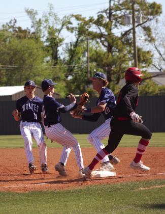 Three Shawnee Wolves collide while trying to catch the ball, as Dale’s Denton Forsythe steps on first base during the Bill Tipton Classic game at Shawnee on April 11. The Pirates won all four of their games, as well as the tournament. They beat Shawnee, 9-6; Eisenhower, 6-0; Piedmont, 7-3; and Elgin, 14-6, over three days. Countywide &amp; Sun/ Natasha Dunagan