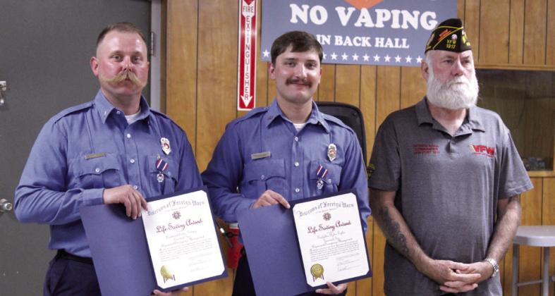 Tecumseh firefighters Lt. Eddie Kidney and Dylan Taylor received VFW Life Saving Award medals and certifi cates from Post 1317 Commander Patrick Koch (right). After responding to a vehicle swept away by fl ood waters, they deployed a rescue boat and saved one victim. 'These two fi refi ghters embody the very essence we all strive for with professionalism, and I'm truly proud to recommend them both to the VFW First Responders Recognition Program,' said Koch. Natasha Dunagan, Countywide &amp; Sun