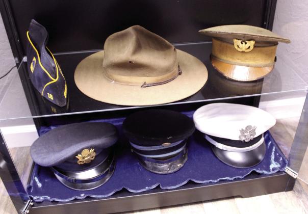 A new display case at the Shawnee American Legion Gill-Mattox Post 16 features military hats from different branches and eras.
