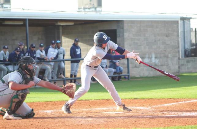 Shawnee junior Easton O’Dell hits a single in the home game against Bishop McGuinness during the Bill Tipton Classic on April 7.