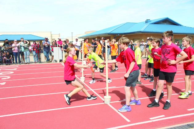 Teams from North Rock Creek, South Rock Creek, Pleasant Grove and Grove compete in the 800 meter shuttle relay. Natasha Dunagan, Countywide &amp; Sun