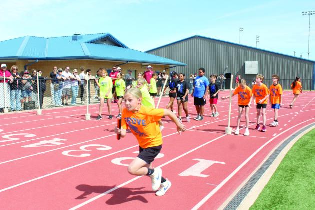 Teams from South Rock Creek, Pleasant Grove and Grove compete in the 800 meter shuttle relay.
