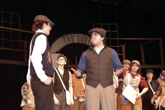 Davey (Jonas Hill) discusses the Newsies strike details with Jack (Cooper Lincoln).