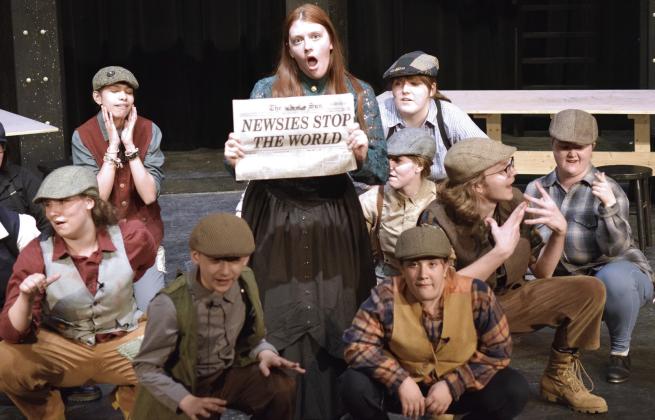 Katherine Plumber (Maya Corley) shows off the Newsies printed paper. Photo by Savannah Talton