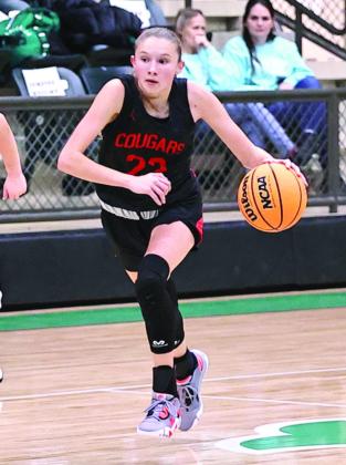 Pictured right, North Rock Creek’s Kadence Munn brings the ball up the court.