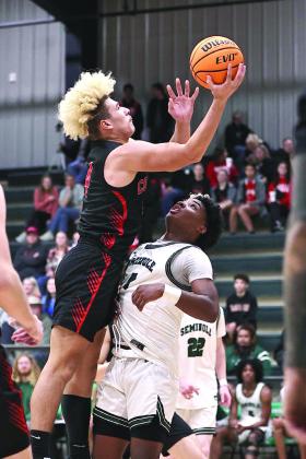 Pictured above, North Rock Creek’s JJ Mc-Clain shoots over the Seminole defender.