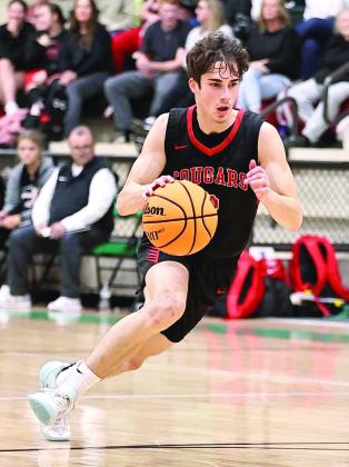 Pictured left, North Rock Creek’s David King drives the lane.