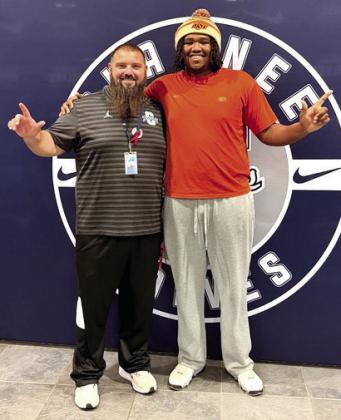 Coach Jason Madonna poses with Evans.