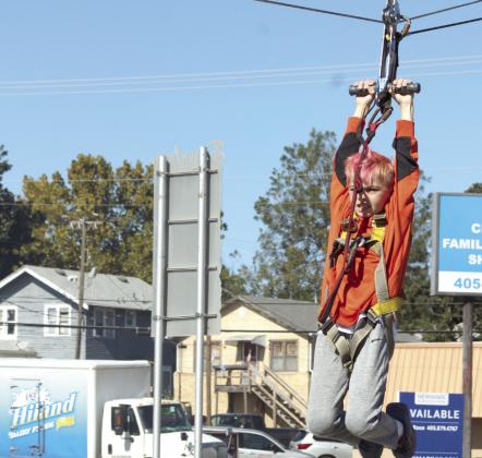 Ryan Flores, 10, of Shawnee, speeds along on the Extreme Inflatables Zipline. The zipline was free, as was the ferris wheel, petting zoo, face painting, games, balloon creations and costume contests at Shawnee Fall Fest on Nov. 1.