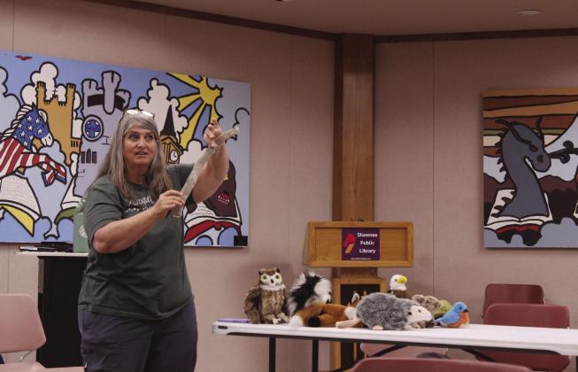 Wildcare OK Executive Director Inger Giuffrida holds up a snake skin for the audience to identify during the 'Mammals in Your Back Yard' program at Shawnee Public Library on July 1. Giuffrida spoke about wildlife living in Oklahoma and ways to help them. She was assisted by longtime volunteer Debbie Saltzman and said they rehabilitate more than 200 species in Noble.