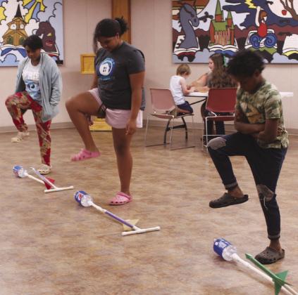 Lyla George, 11, Jasmine George, 13 and Kal-el George, 10, all of Tecumseh, prepare to launch the rockets they built at the 'Built It: Ready, Set, Blast Off!' program on June 30 at Shawnee Public Library. The next Build It event is 'Zip Line Zoom!' on July 21 at 2 pm. For a full list of events, visit the Pioneer Library System website.