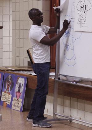 Gordon demonstrated drawing cowboys, sharks, rhinos and dynamic lettering for the class. Gordon is known for his paintings of dogs, superhero cats, and caricatures.