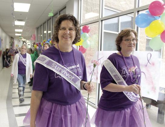Cancer survivors Tina Thompson and Tiffany O'Neal walk the first lap of Relay for Life, held at Shawnee Early Childhood Center on the afternoon of April 26. Natasha Dunagan, Countywide &amp; Sun