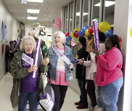 Cancer survivors Linda Weston and Marti Wolf walk the first lap of Relay for Life. About seven fund-raising teams and 28 survivors attended this year. Natasha Dunagan, Countywide &amp; Sun
