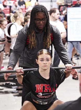 North Rock Creek’s Elektra Coughran does one of her three squats.