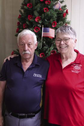 American Legion Post 260 Commander and Navy Veteran Tom Snodgrass and Donna Snodgrass, American Legion State Auxiliary 1st Vice President, pose by the 'poppy tree' at the Tecumseh post. Natasha Dunagan, Countywide &amp;amp; Sun